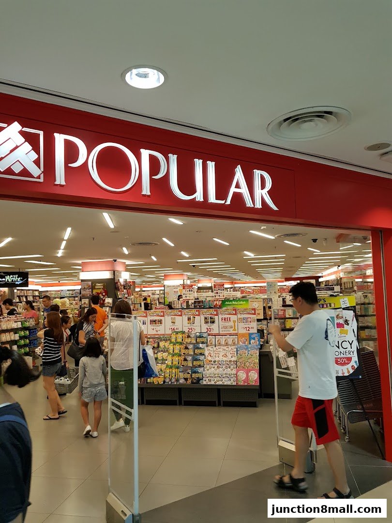 Entrance to a POPULAR Bookstore with customers browsing inside.