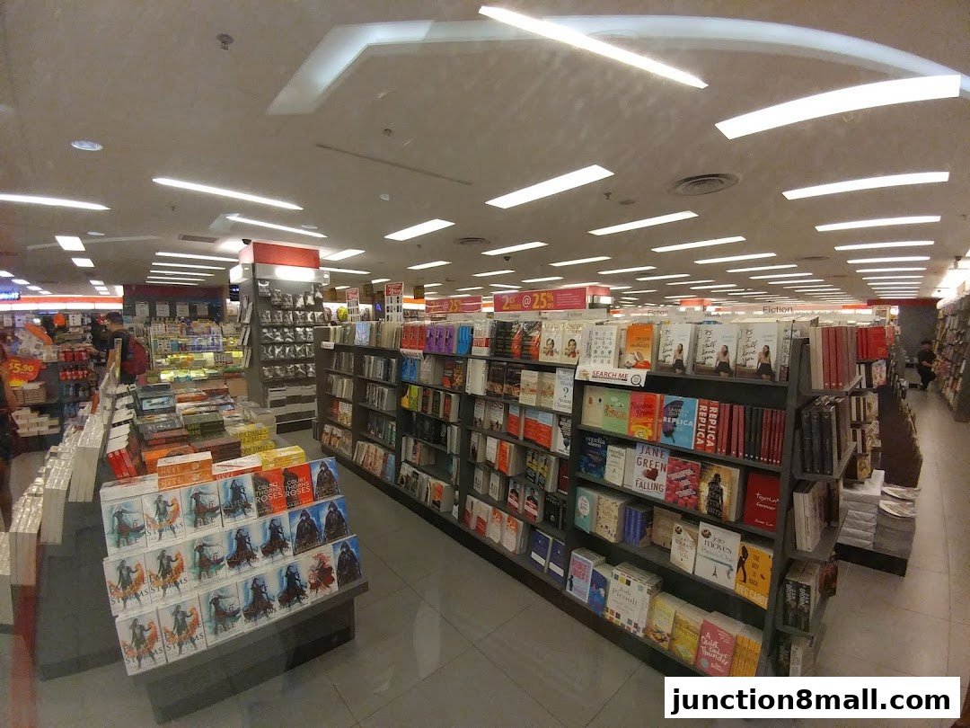 Interior view of a well-lit bookstore with shelves full of books and displays.
