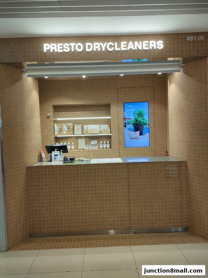 The clean and modern storefront of Presto Drycleaners, featuring a tiled counter and illuminated signage.
