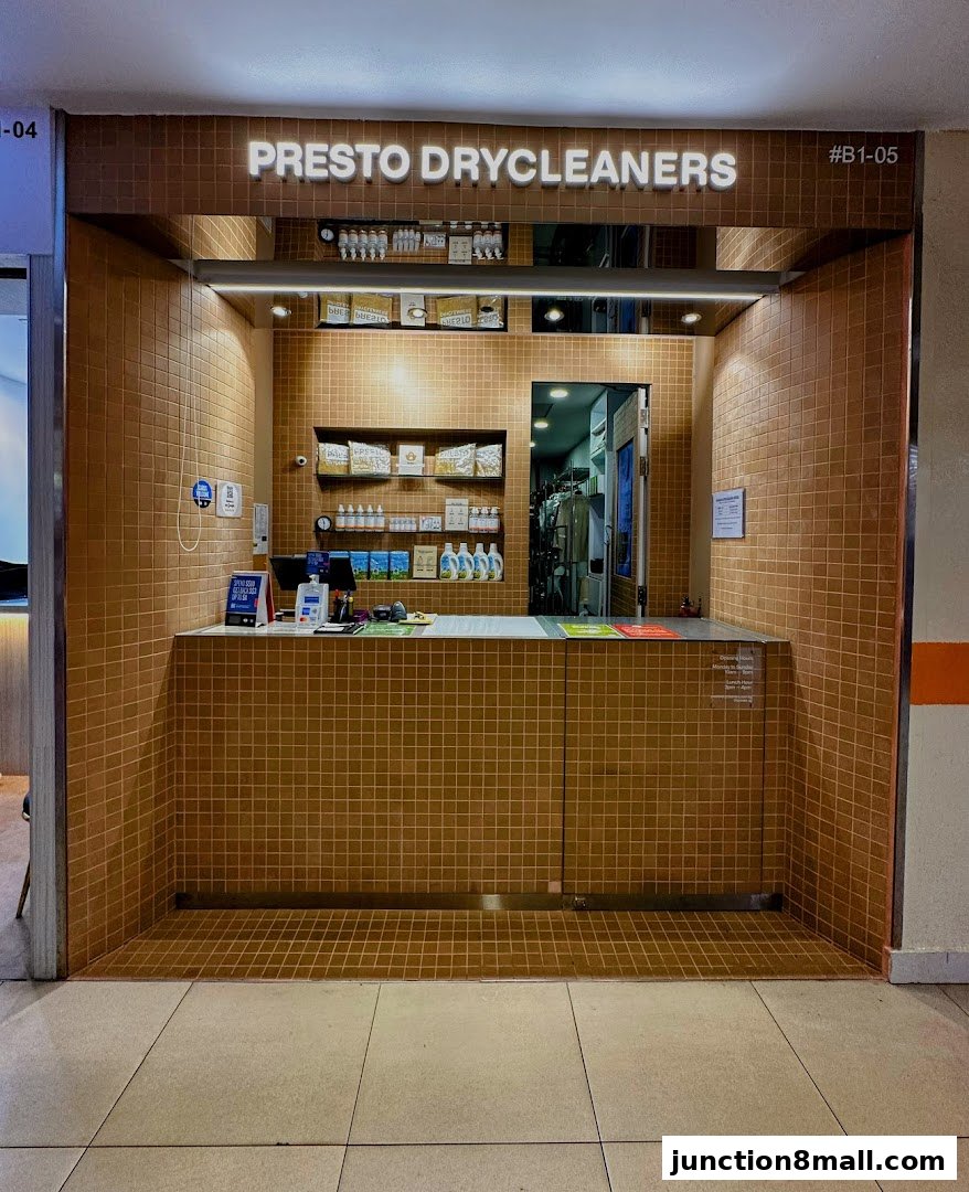 The entrance of Presto Drycleaners, featuring a tiled counter and shelves with products.