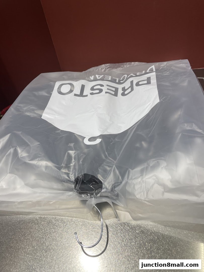 A plastic bag with the Presto Drycleaners logo and a hanger inside.
