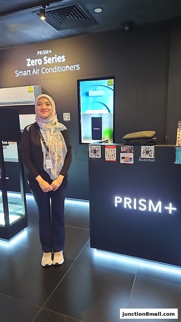 A woman stands at the counter of a PRISM+ store, showcasing smart air conditioners.