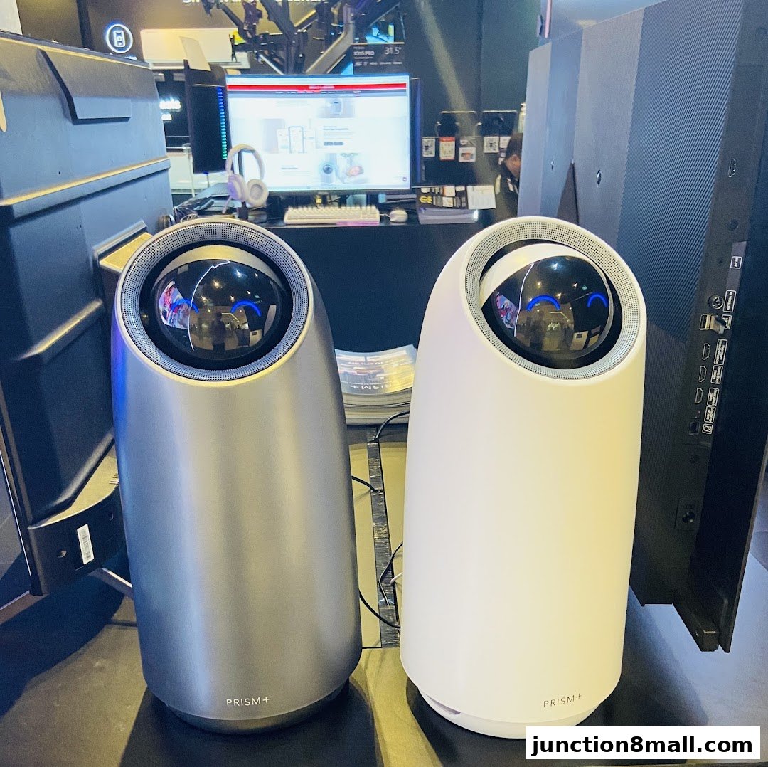 Two futuristic-looking speakers, one silver and one white, are displayed in a retail setting.