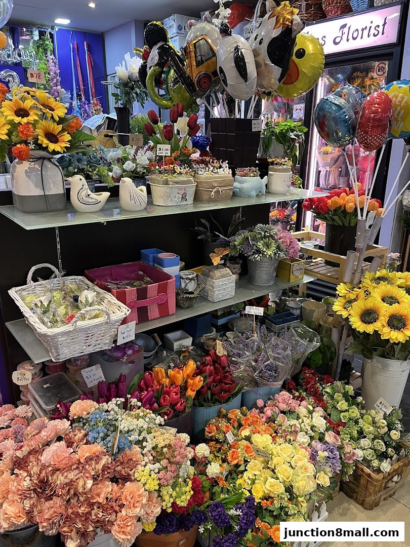 A vibrant display of artificial flowers, balloons, and decorative items at Raffles Florist.