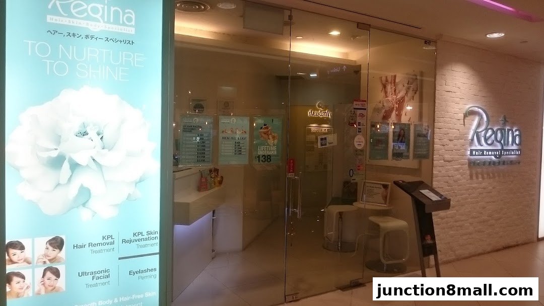 The entrance of Regina Hair Removal Specialist shop with a large illuminated sign and posters.