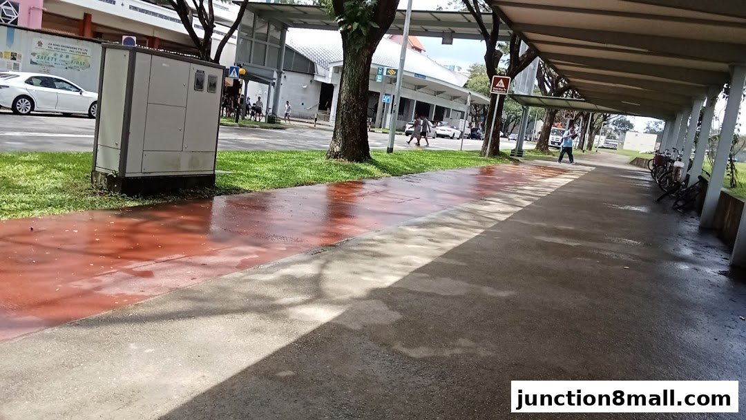 A covered walkway with bicycles parked and a person walking.