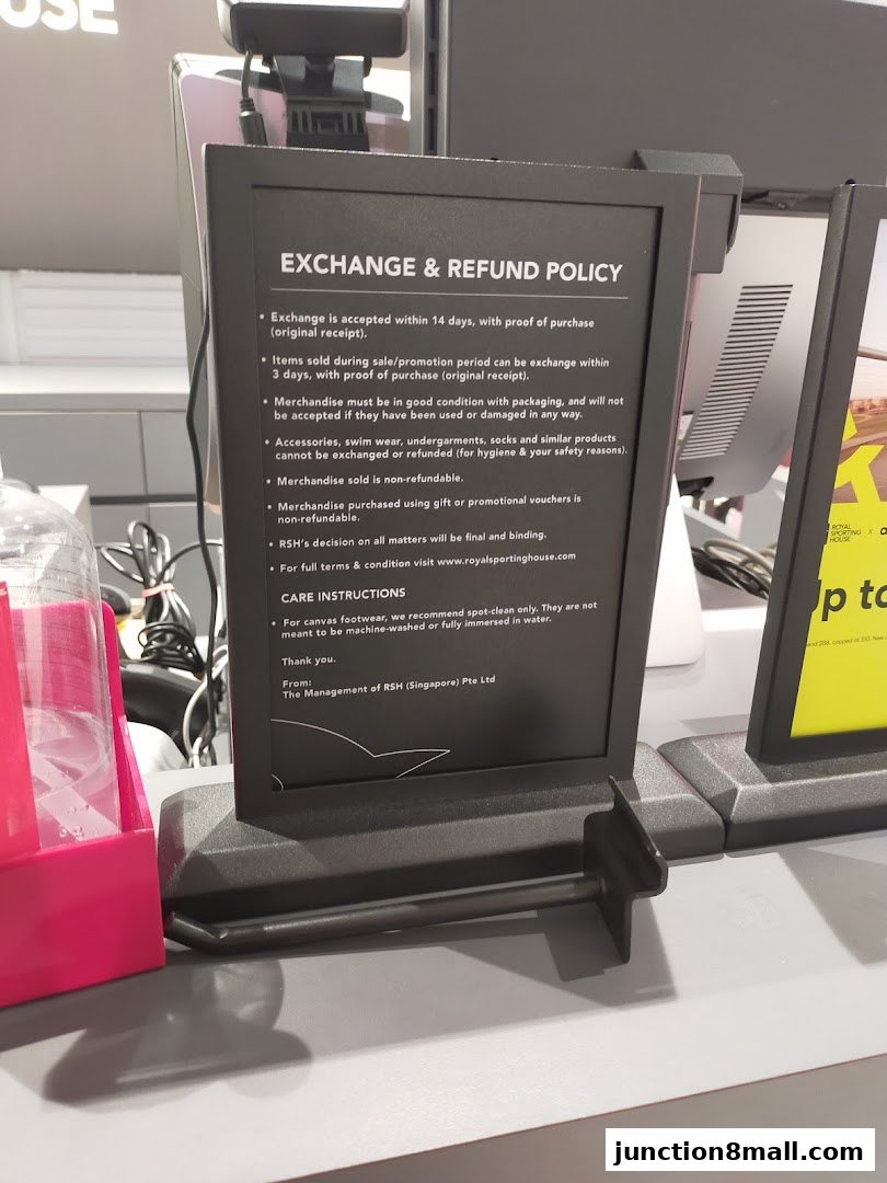 A sign detailing the exchange and refund policy at Royal Sporting House.