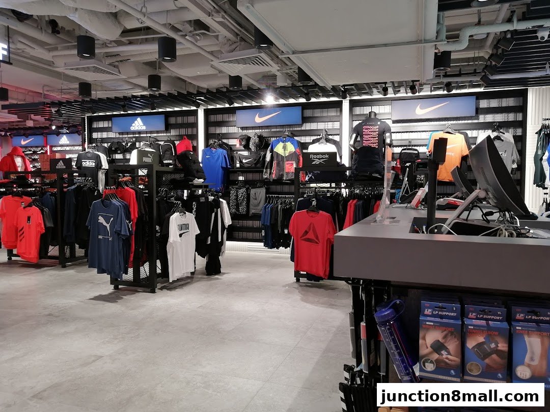 Interior view of a sports apparel store showcasing branded clothing and accessories.