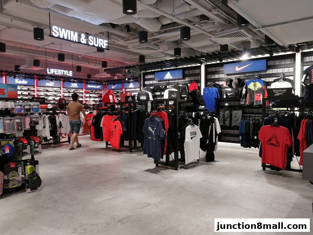 Interior view of a sports apparel store with clothing and shoes displayed.