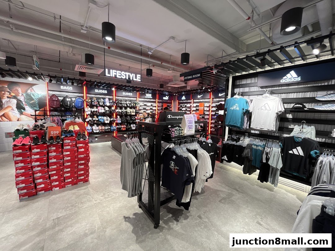 Interior view of a sports apparel store showcasing clothing, shoes, and accessories.