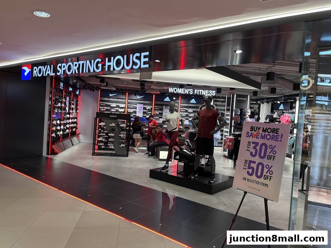 The entrance of Royal Sporting House, showcasing athletic wear and footwear with a promotional sign.