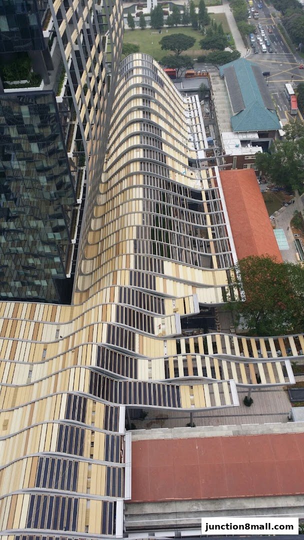 Aerial view of a modern building with a unique wavy facade and balconies.