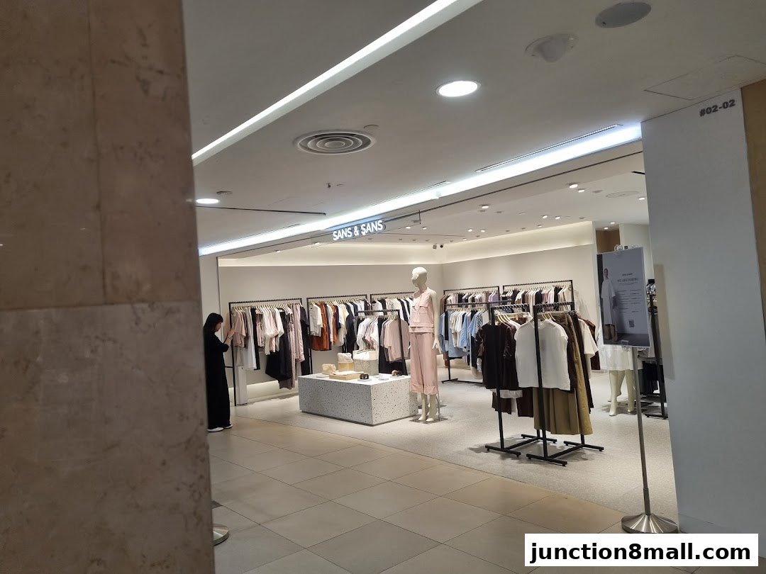 Interior view of a clothing store with mannequins and racks of apparel.