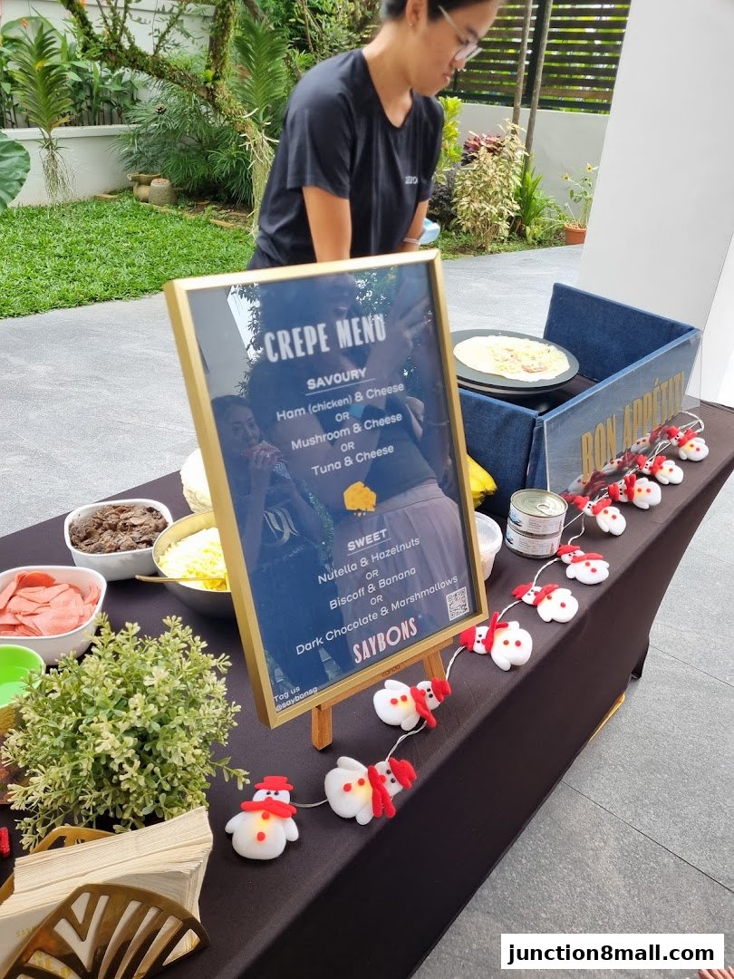 A crepe menu displayed on a table with ingredients and festive decorations.