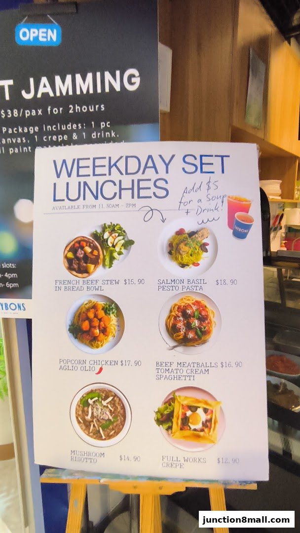 A menu board displays various weekday set lunch options with prices and enticing images.