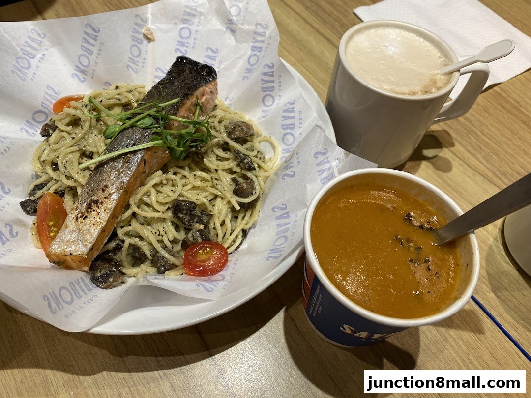 A delicious meal featuring salmon pasta, soup, and a hot beverage.