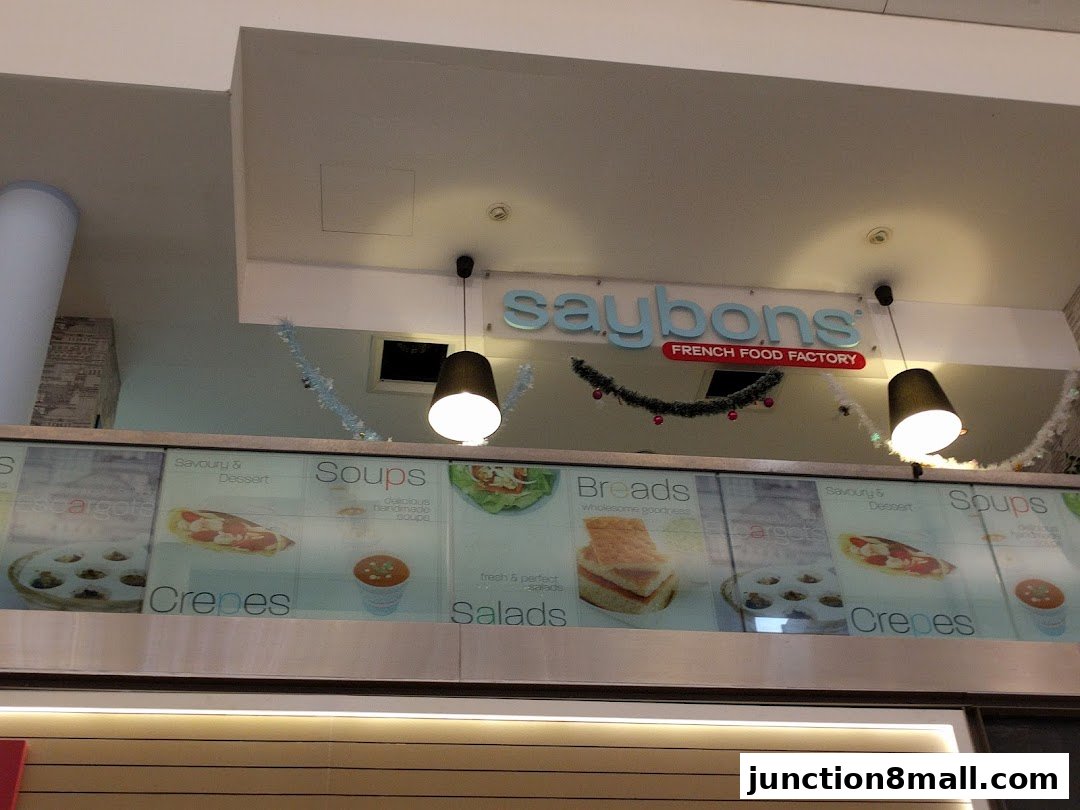 The Saybons French Food Factory shop front with a menu display showcasing various food items.