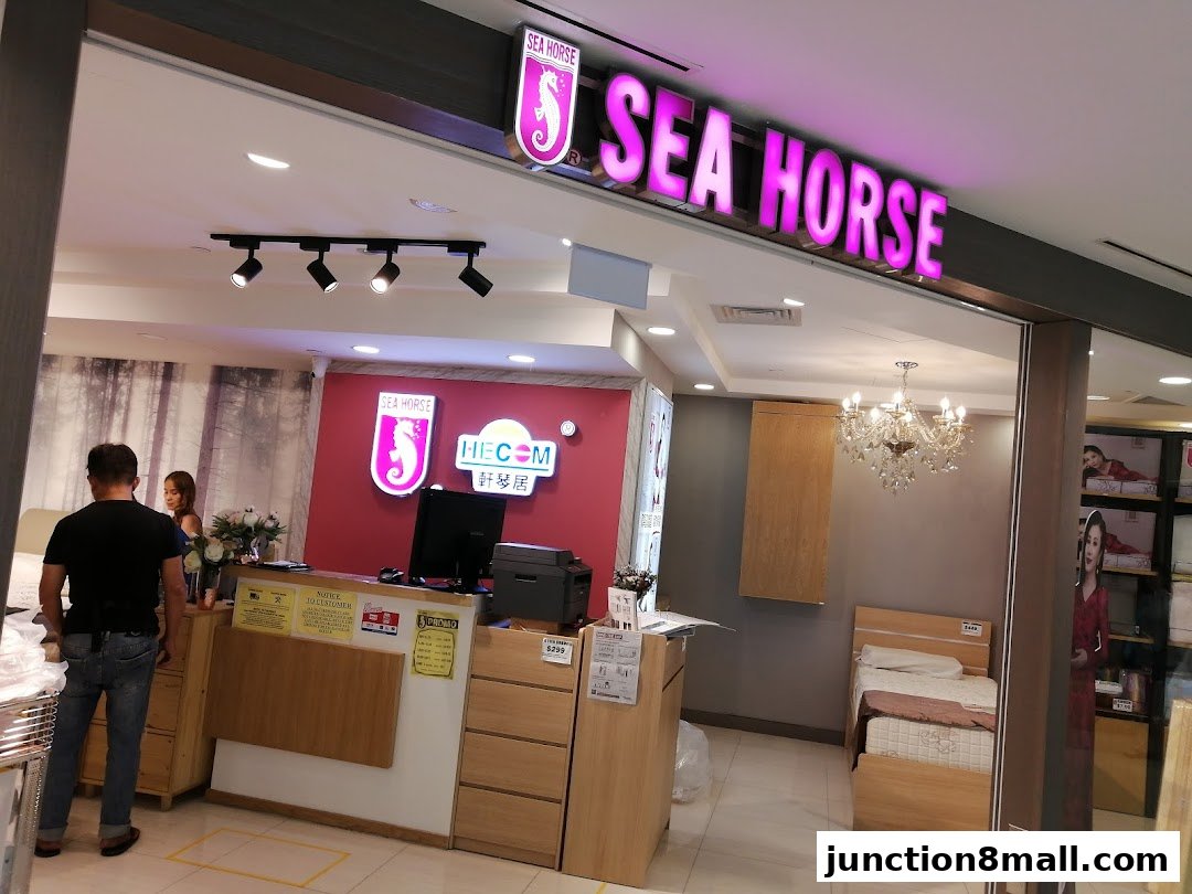 The entrance of the Sea Horse furniture store, showcasing beds and a reception area.