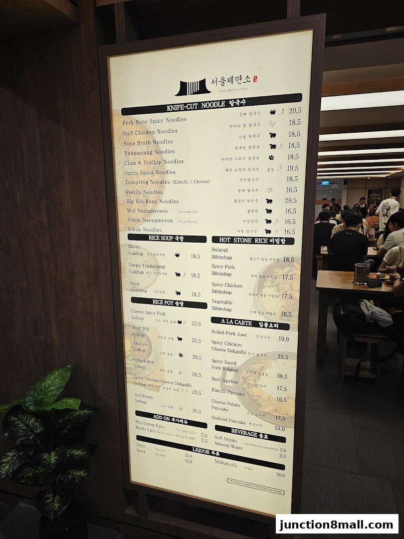 A menu board for Seoul Noodle Shop, displaying various noodle dishes, rice pots, and beverages.