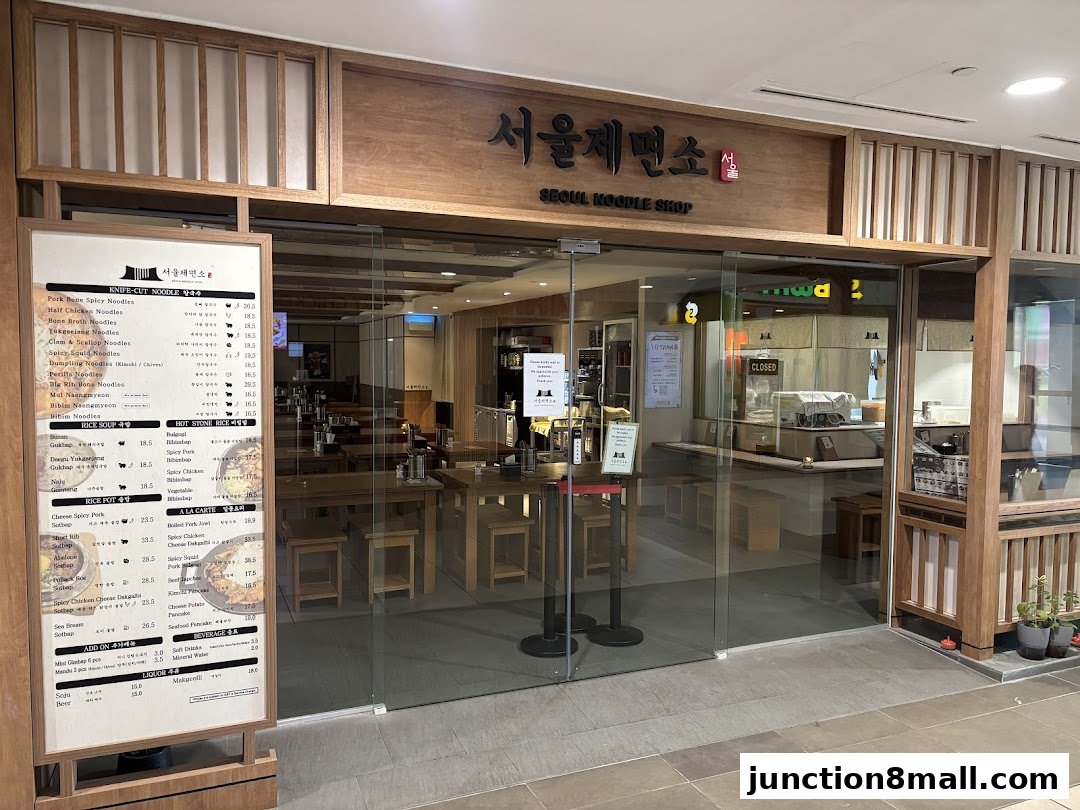 The entrance of Seoul Noodle Shop with a menu board displayed outside.