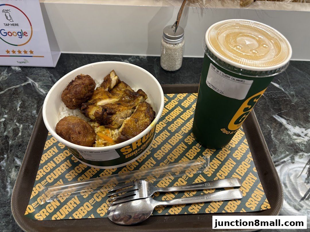 A bowl of rice with grilled chicken and fried items, and a drink on a tray.