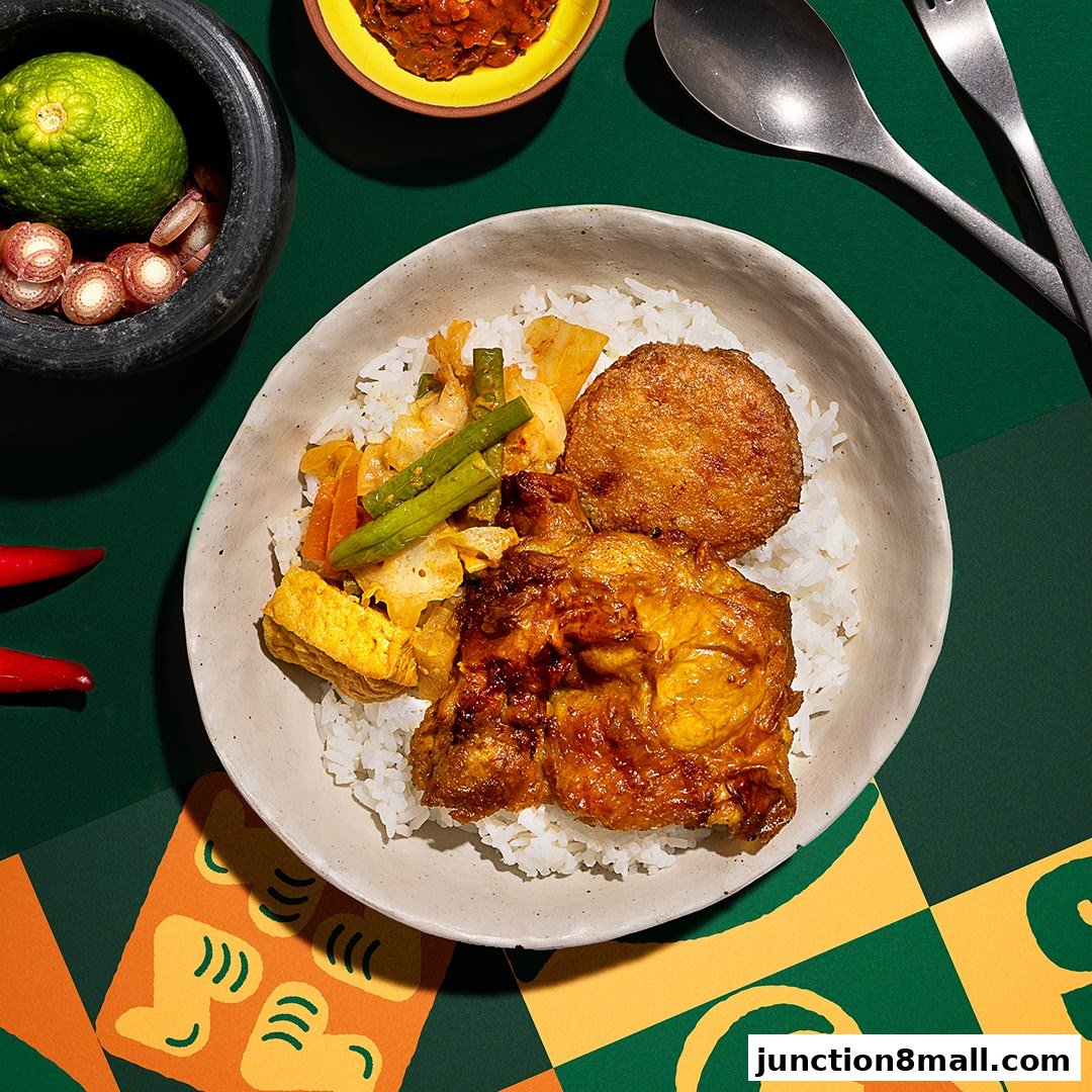 A delicious bowl of Nasi Padang with chicken, patty, vegetables, and sambal.