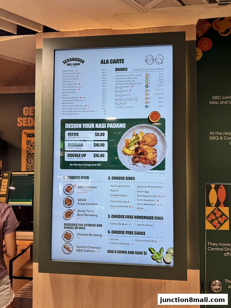 A digital menu board displays a variety of BBQ, curry, and Nasi Padang dishes with prices.