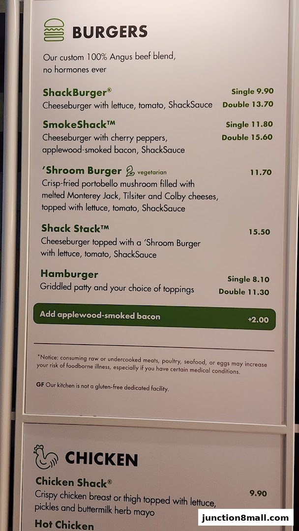 A menu board displaying various burgers and chicken items with prices.