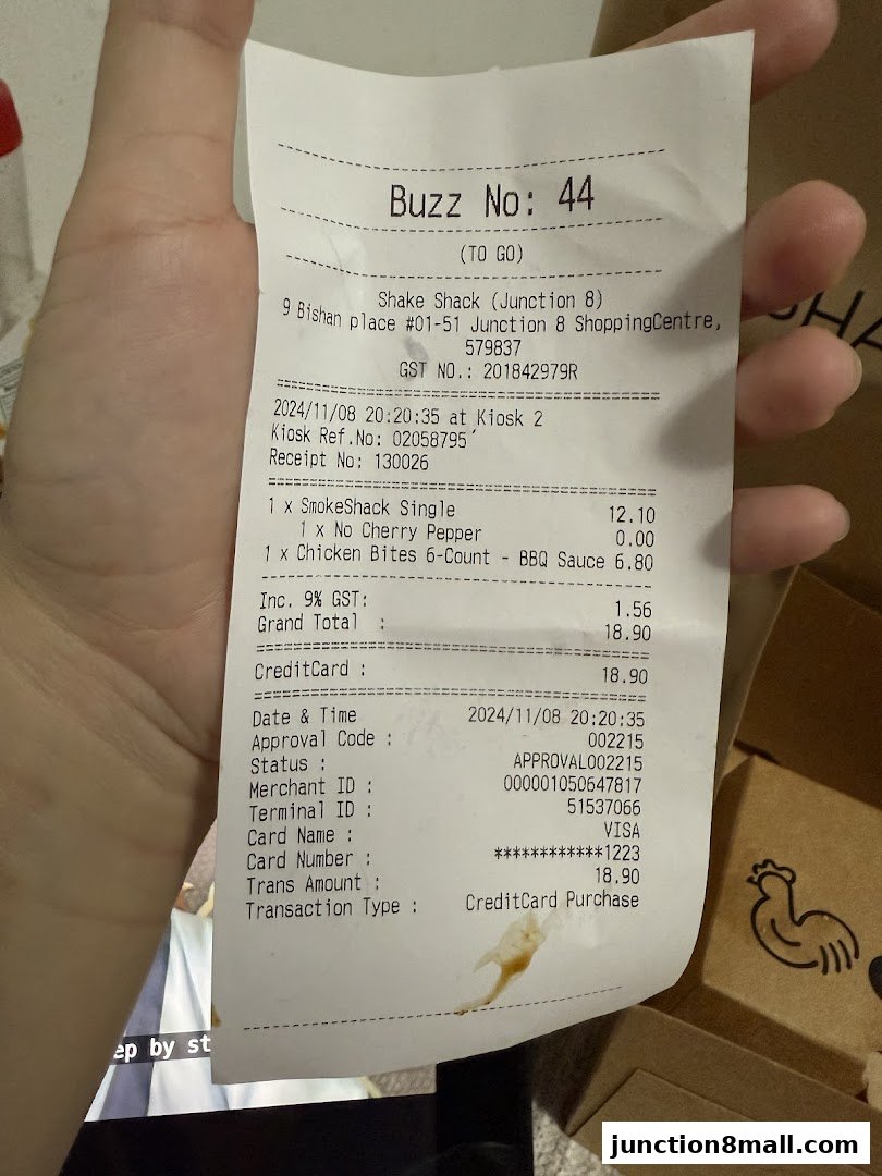 A receipt from Shake Shack Junction 8 showing food items and payment details.