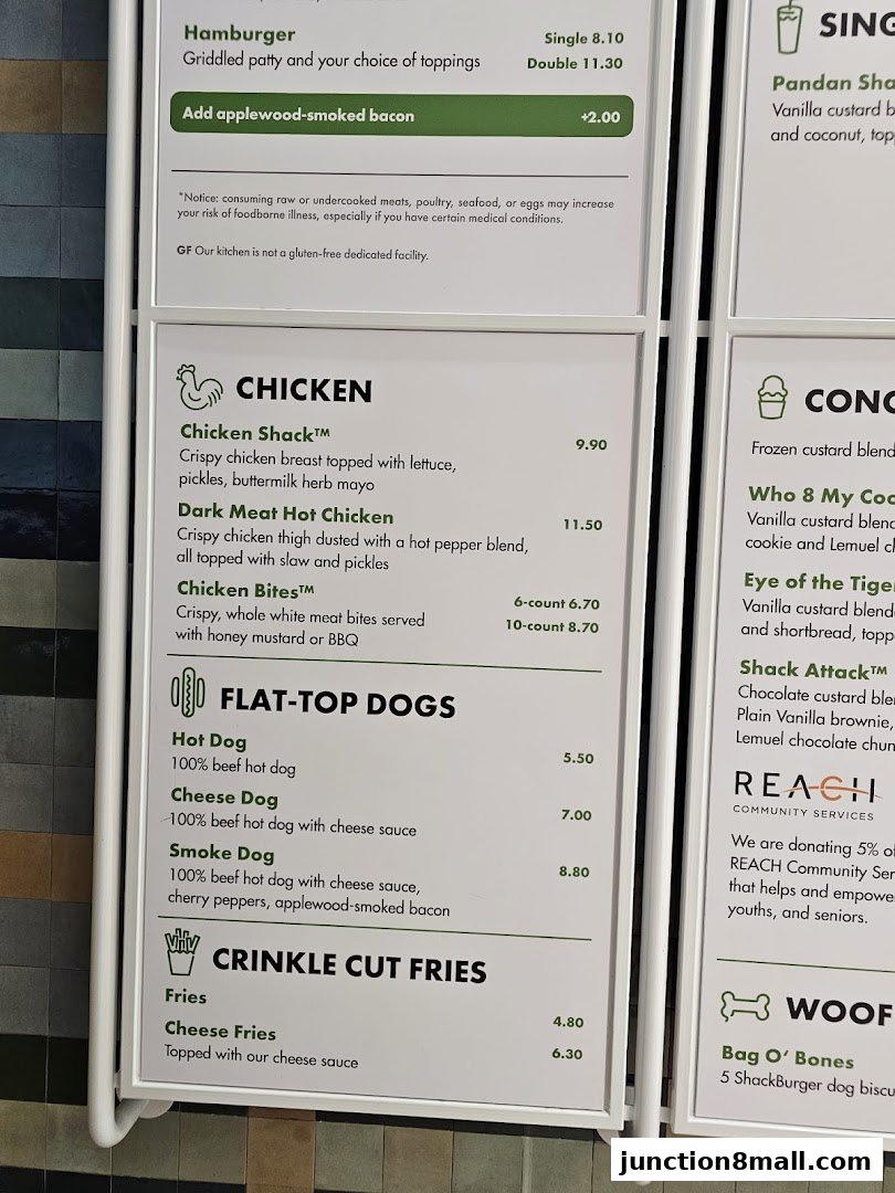 A menu board displaying various chicken dishes, hot dogs, and fries with prices.