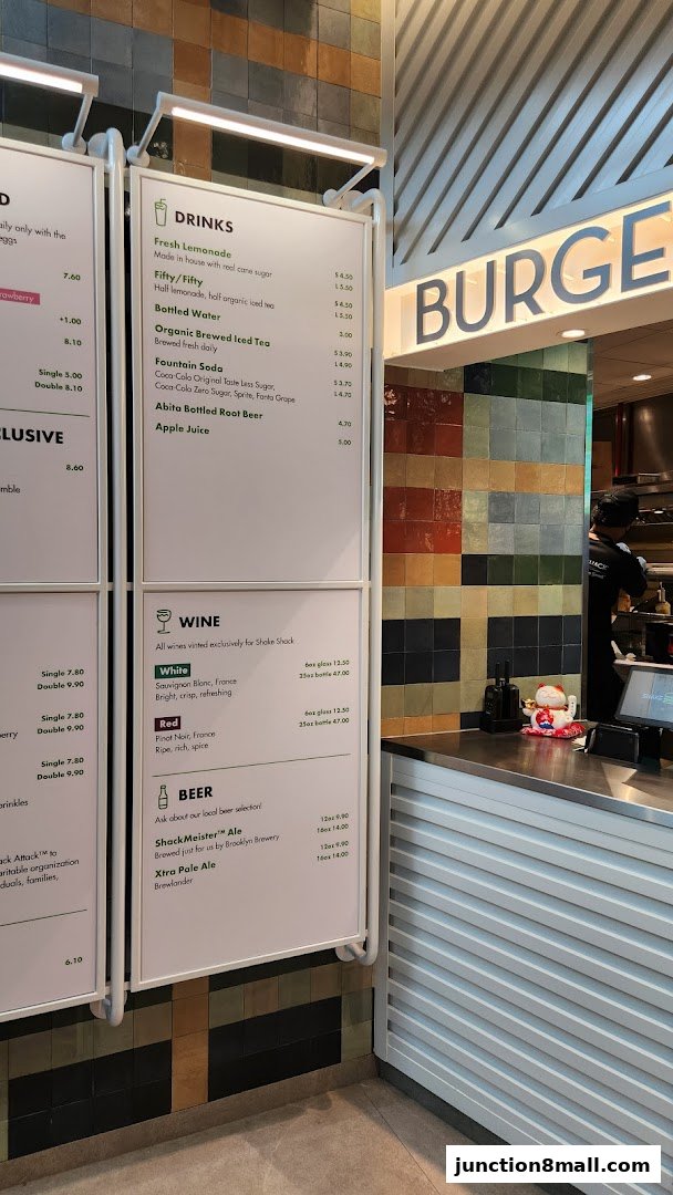 A menu board displaying drinks, wine, and beer options at Shake Shack.