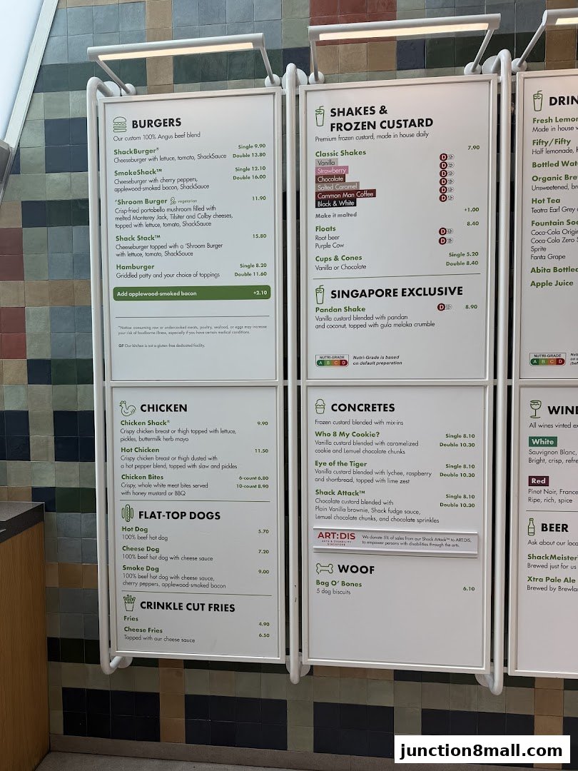 A menu board displaying burgers, shakes, chicken, hot dogs, fries, concretes, and drinks.