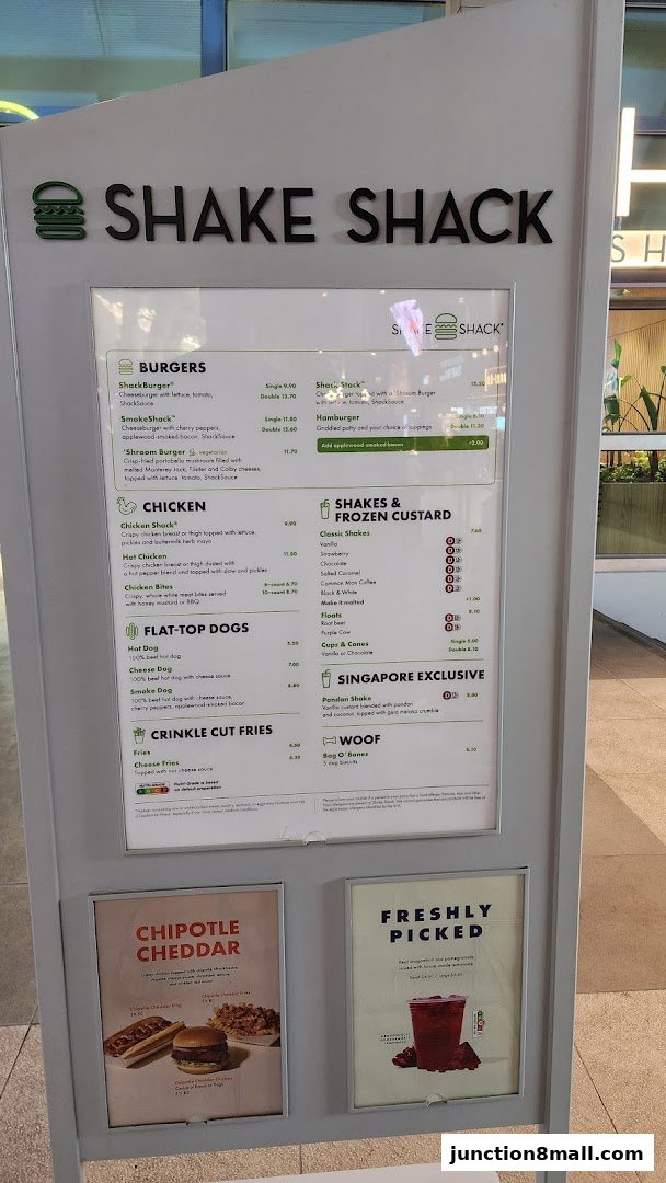 A menu board for Shake Shack featuring burgers, chicken, hot dogs, fries, shakes, and frozen custard.