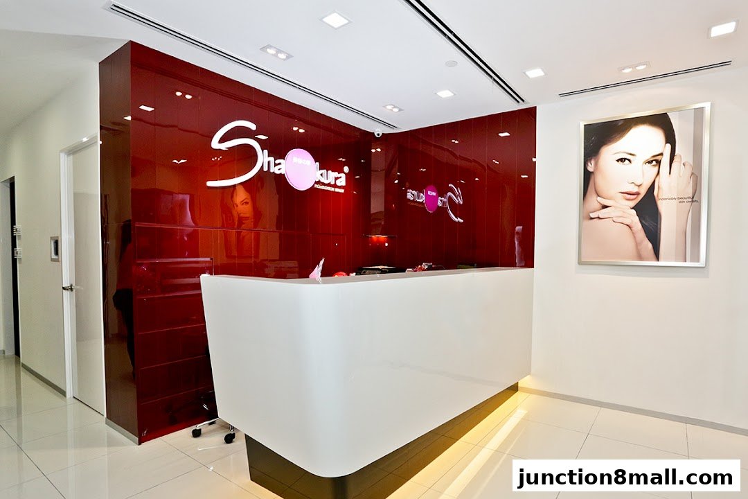 The reception area of Shakura Pigmentation Beauty, featuring a modern white counter and a striking red accent wall.