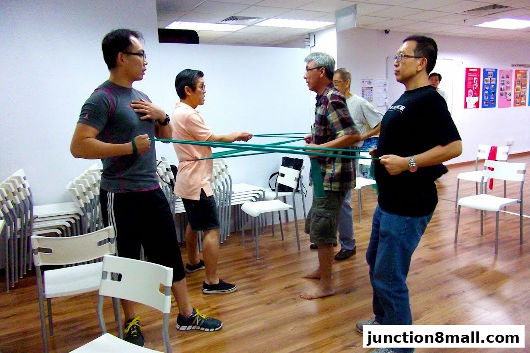 Men participating in a group exercise class using resistance bands.