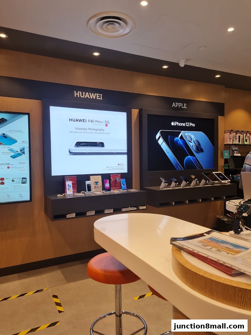 Interior of a Singtel Exclusive Retailer showcasing Huawei and Apple products.