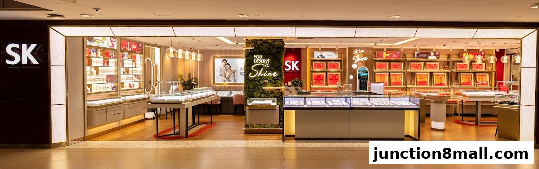 The interior of a brightly lit SK Jewellery store showcasing display cases filled with jewelry.