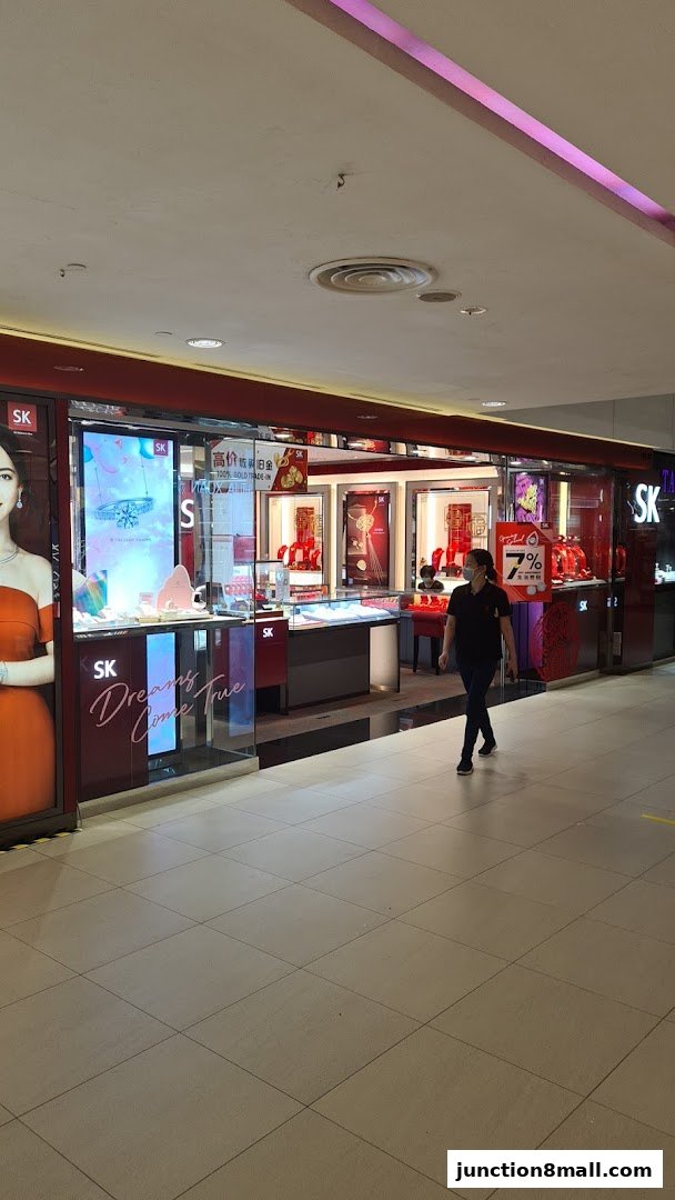 The exterior of the SK Jewellery store, showcasing displays of jewelry and a promotional sign.