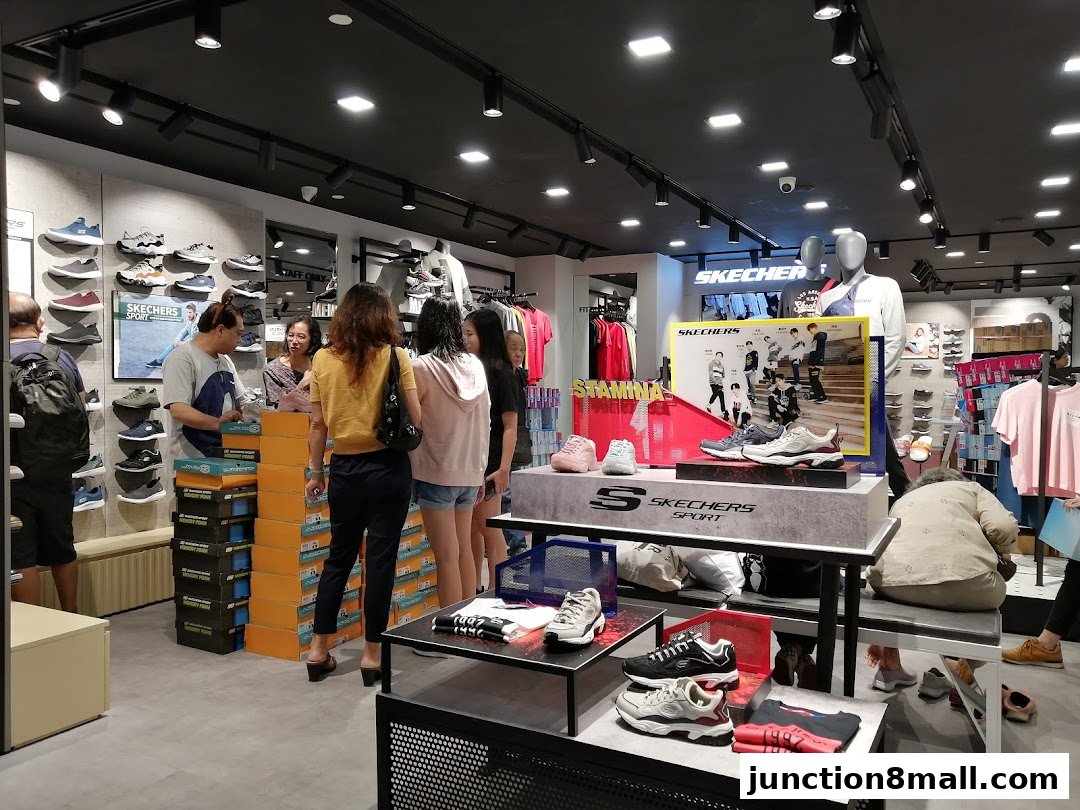 Interior of a Skechers store with shoes displayed on shelves and mannequins.