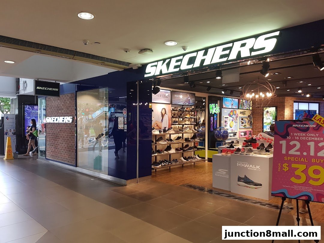 The Skechers store entrance with displays of shoes and a promotional sign.