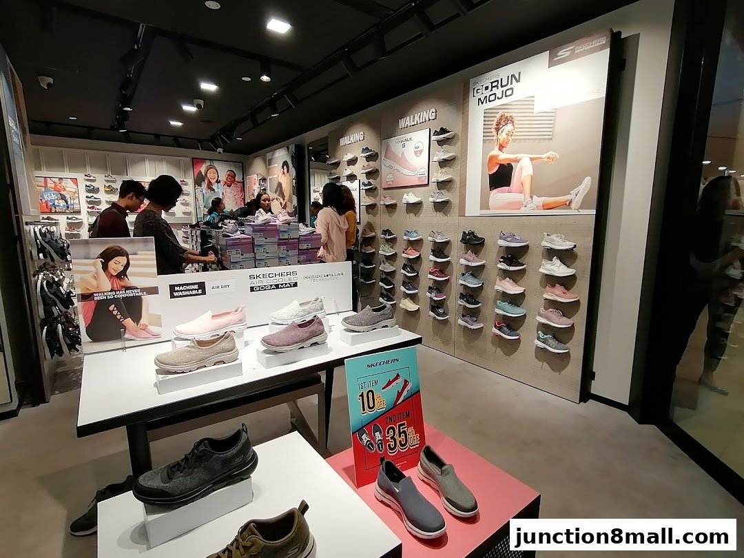 Interior view of a Skechers store showcasing various walking and running shoes on display.