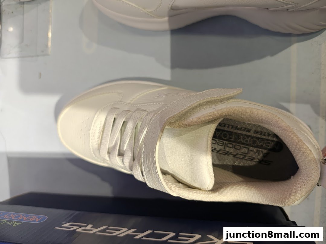 A close-up view of a white Skechers sneaker with visible memory foam and air-cooled features.