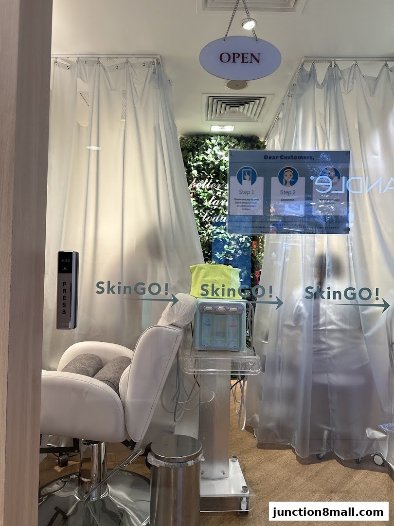 Interior view of a clean, modern beauty treatment room with a chair and equipment.