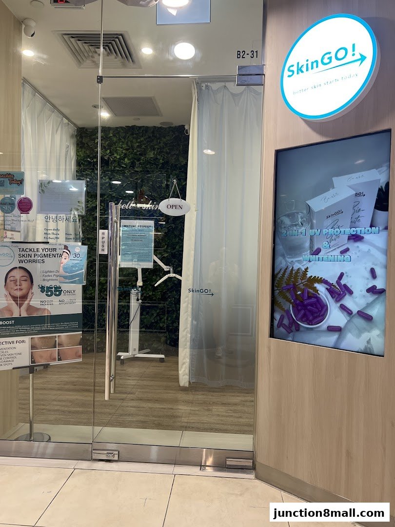 The entrance to SkinGO!, a beauty clinic, featuring a glass door and promotional displays.
