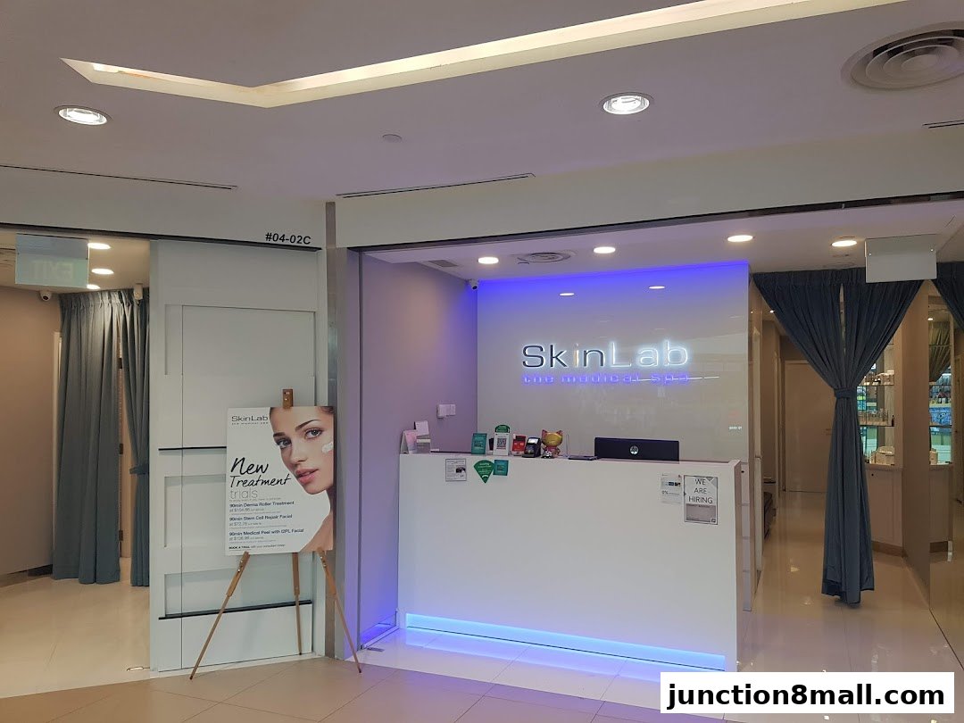 The reception area of SkinLab The Medical Spa, featuring a white counter and illuminated logo.