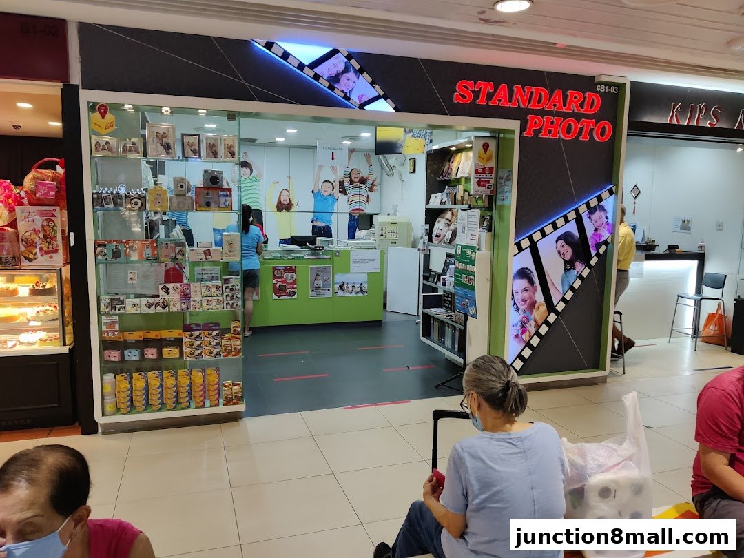 The exterior of a Standard Photo shop with cameras and photo-related products displayed.