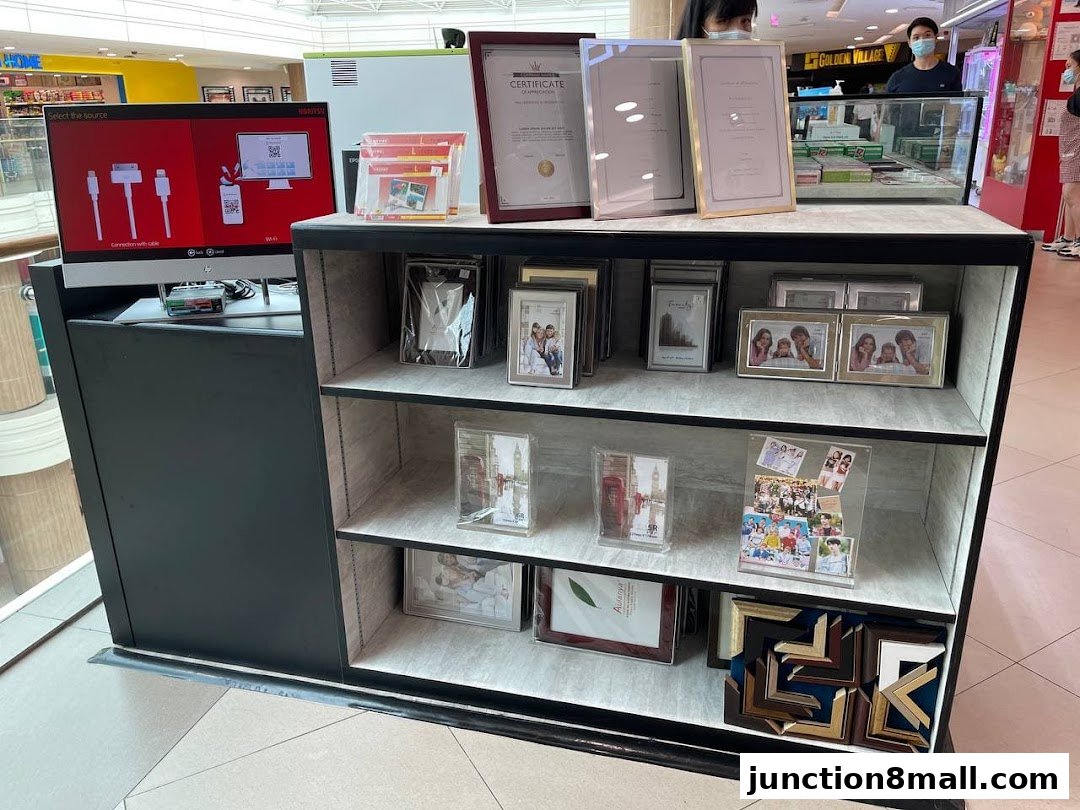 A display of photo frames and a digital photo printing kiosk.