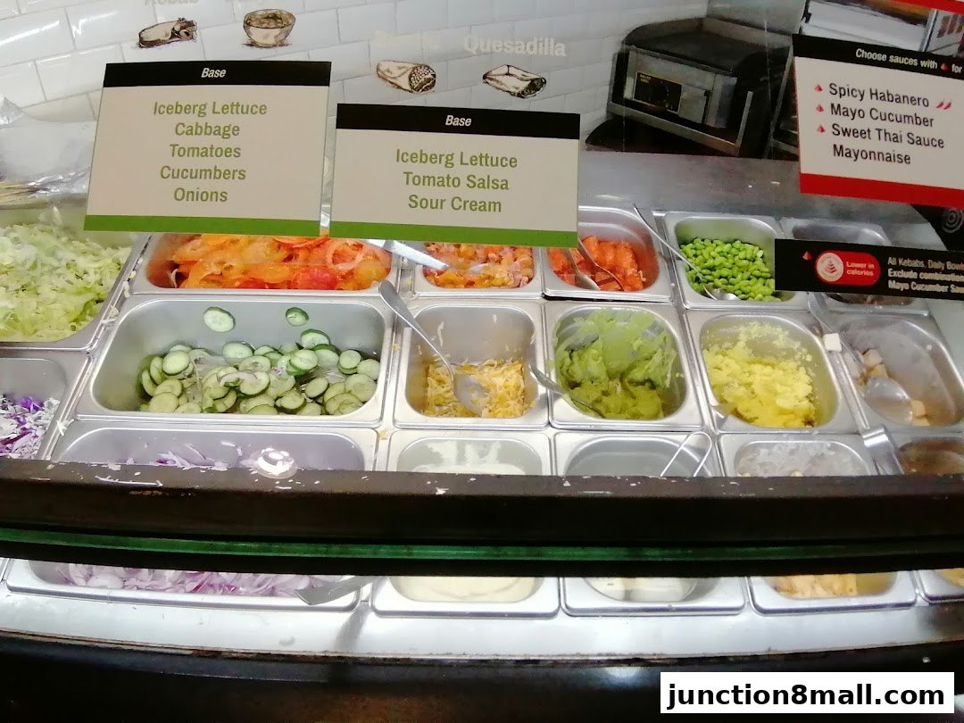 A display of fresh ingredients and sauces for customizable meals at Stuffd.