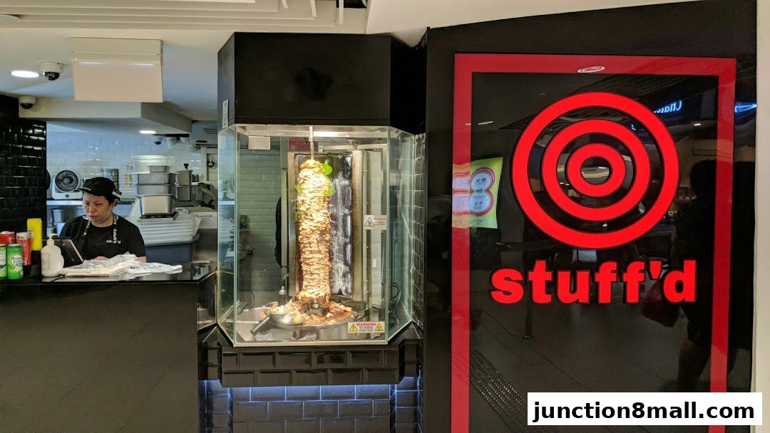 A shop front with a rotating meat skewer and the shop's logo.