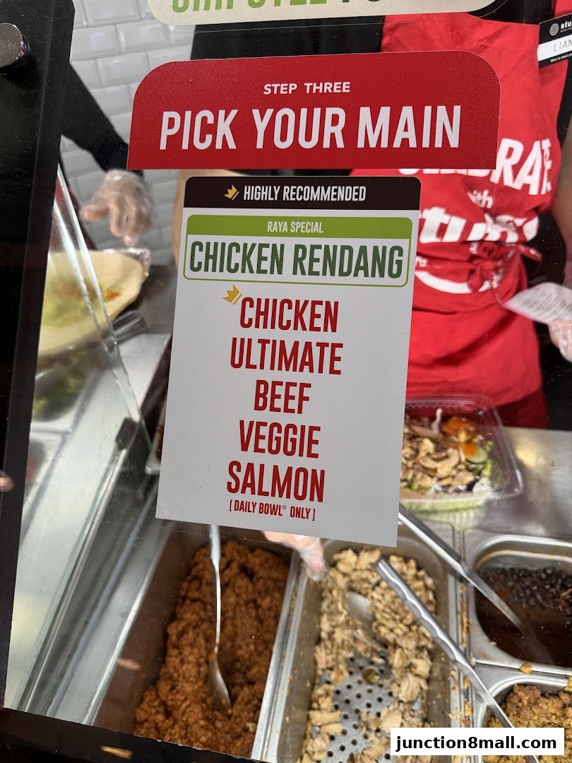 A sign displays main course options including Chicken Rendang, Chicken, Ultimate, Beef, Veggie, and Salmon.